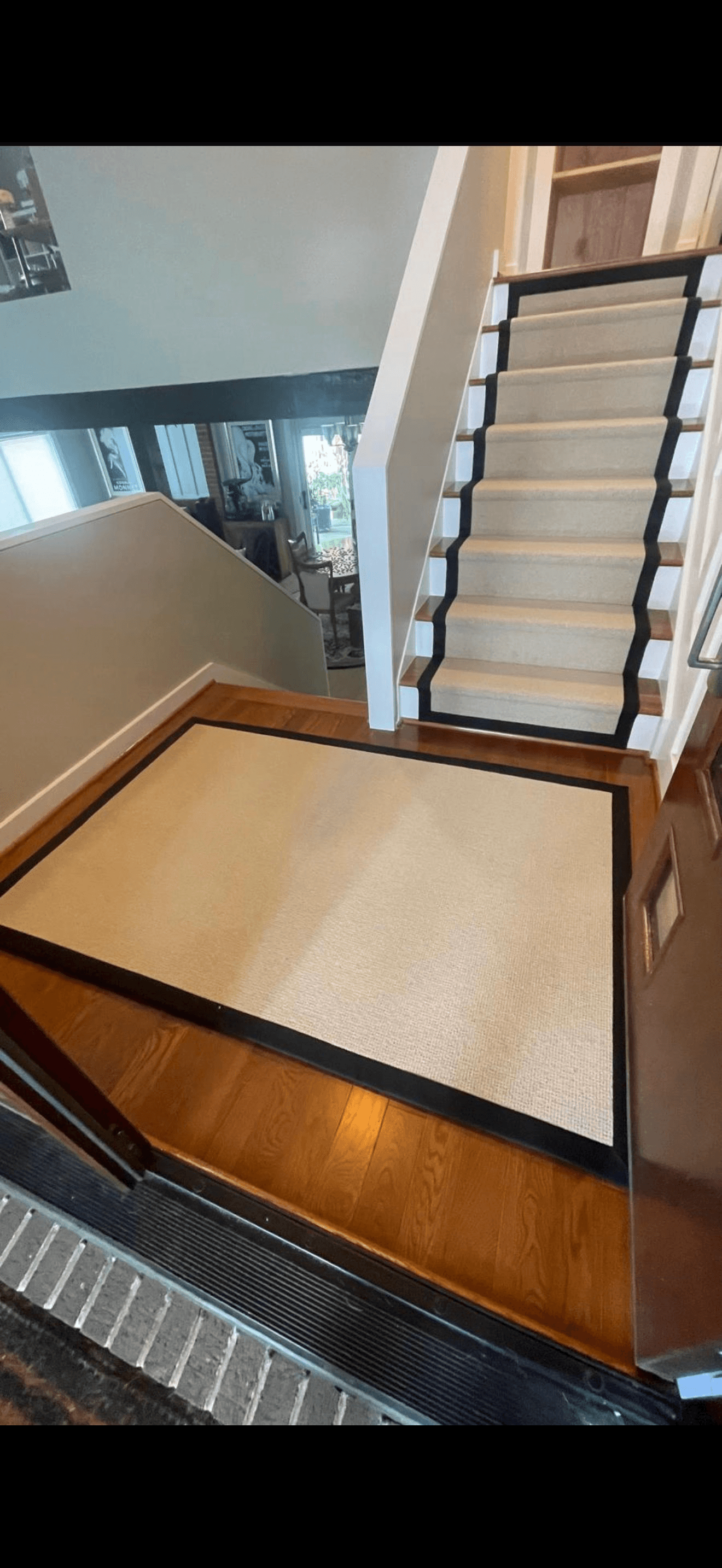 Stair runner with black binding and matching bound landing area rug installed in Northern Virginia home